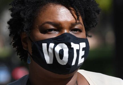 Stacey Abrams apologizes for taking a photo without her mask